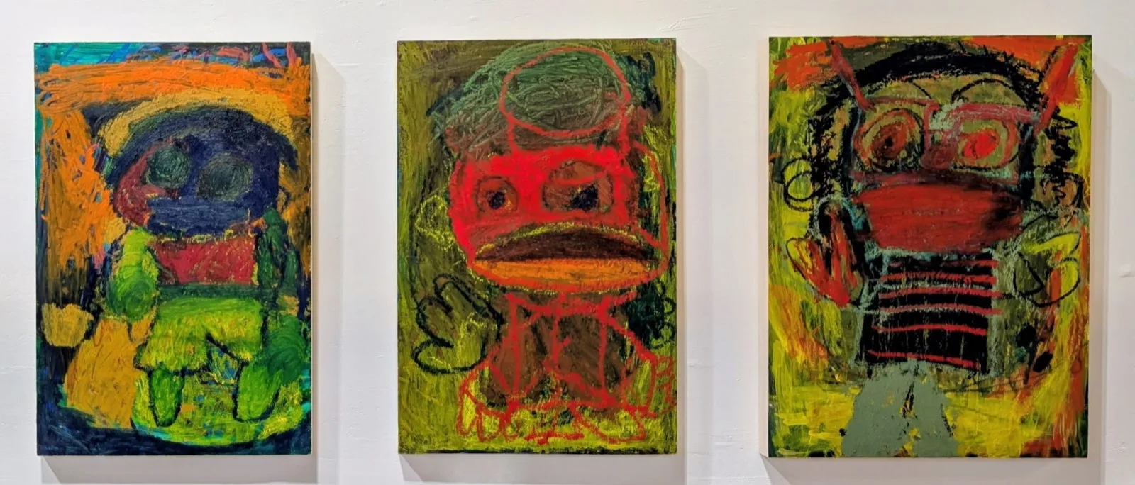 Three colourful portrait paintings by Aaron, featuring an expressive figure with bold outlines and layered green, red, orange, blue, and black tones, 2024