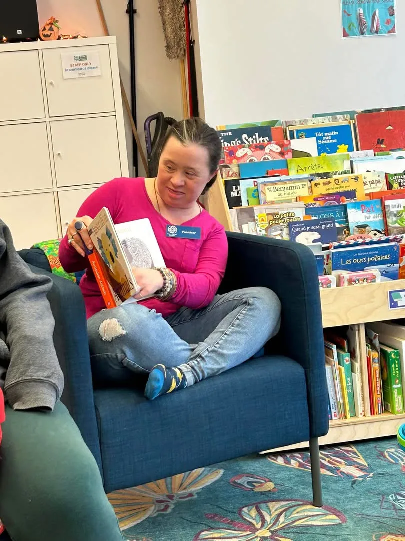 Aimee reading to a group at the local library, 2025