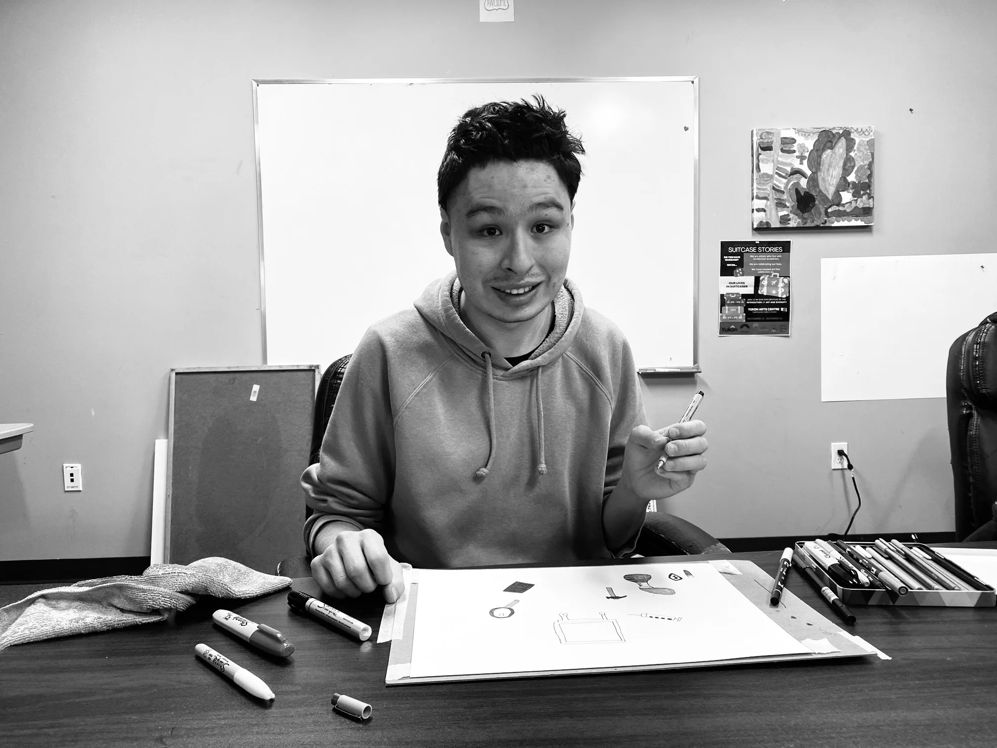 Portrait of Zachary smiling while creating art at TOZ, 2024
