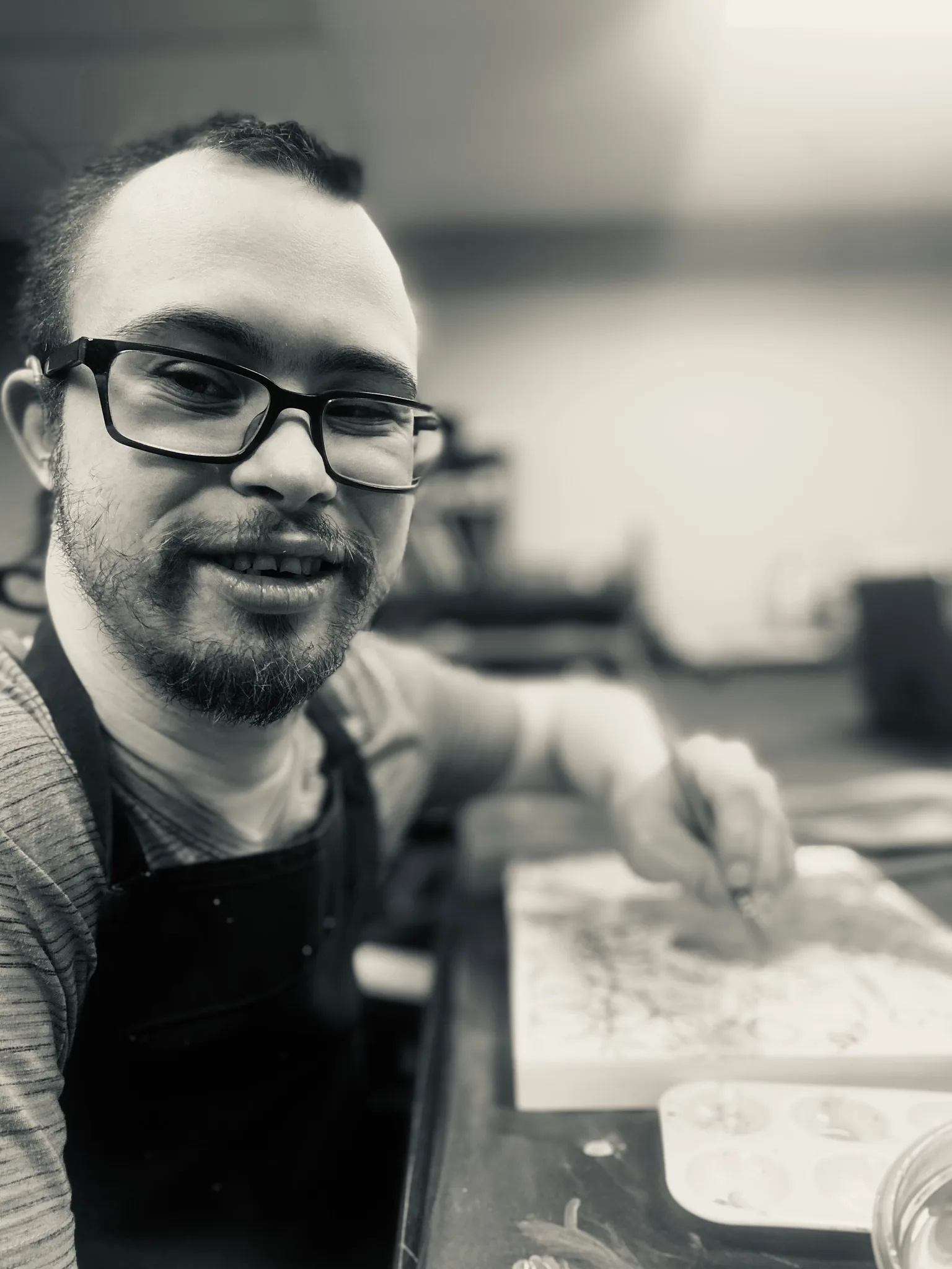 Black and white portrait of Arron creating art, 2024