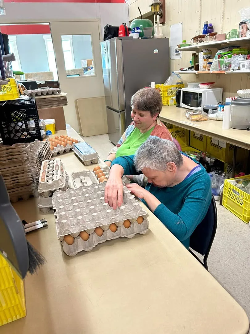 Cheri and Fauve volunteering at the local food bank, 2024