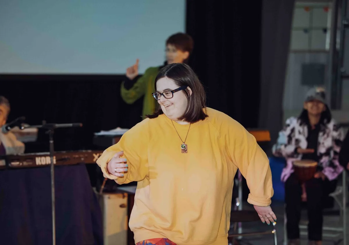 Tijana dancing in front of a group at the Tintina hangar, 2023